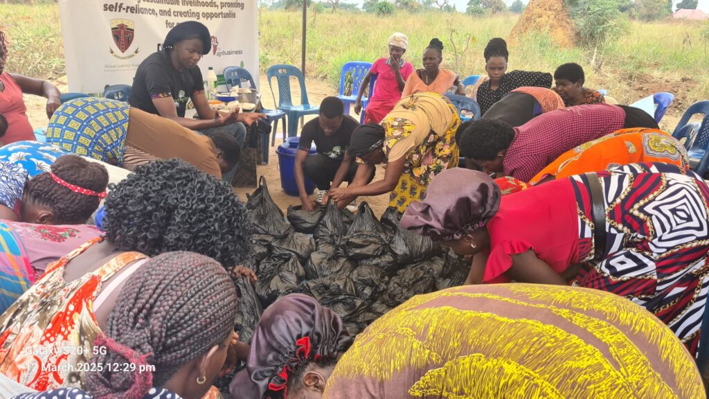 Refugee women and community members attend a mushroom farming training session led by Agri Planet Africa and partners under the Roots of Resilience consortium in the Kyangwali Refugee Settlement, Uganda. Trainers demonstrate techniques while participants engage in discussion.